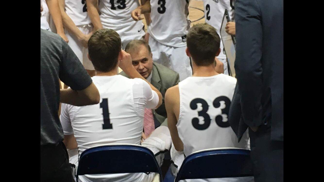 Coach Kaine in a team huddle with Coach Jim Crutchfield